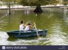 two-girls-trying-to-row-a-paddle-boat-down-the-serpentine-in-london-F5990A.jpg